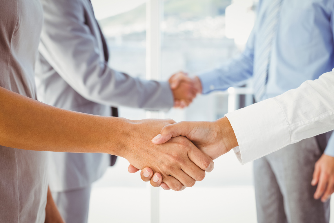 Two fellow employees shaking hands